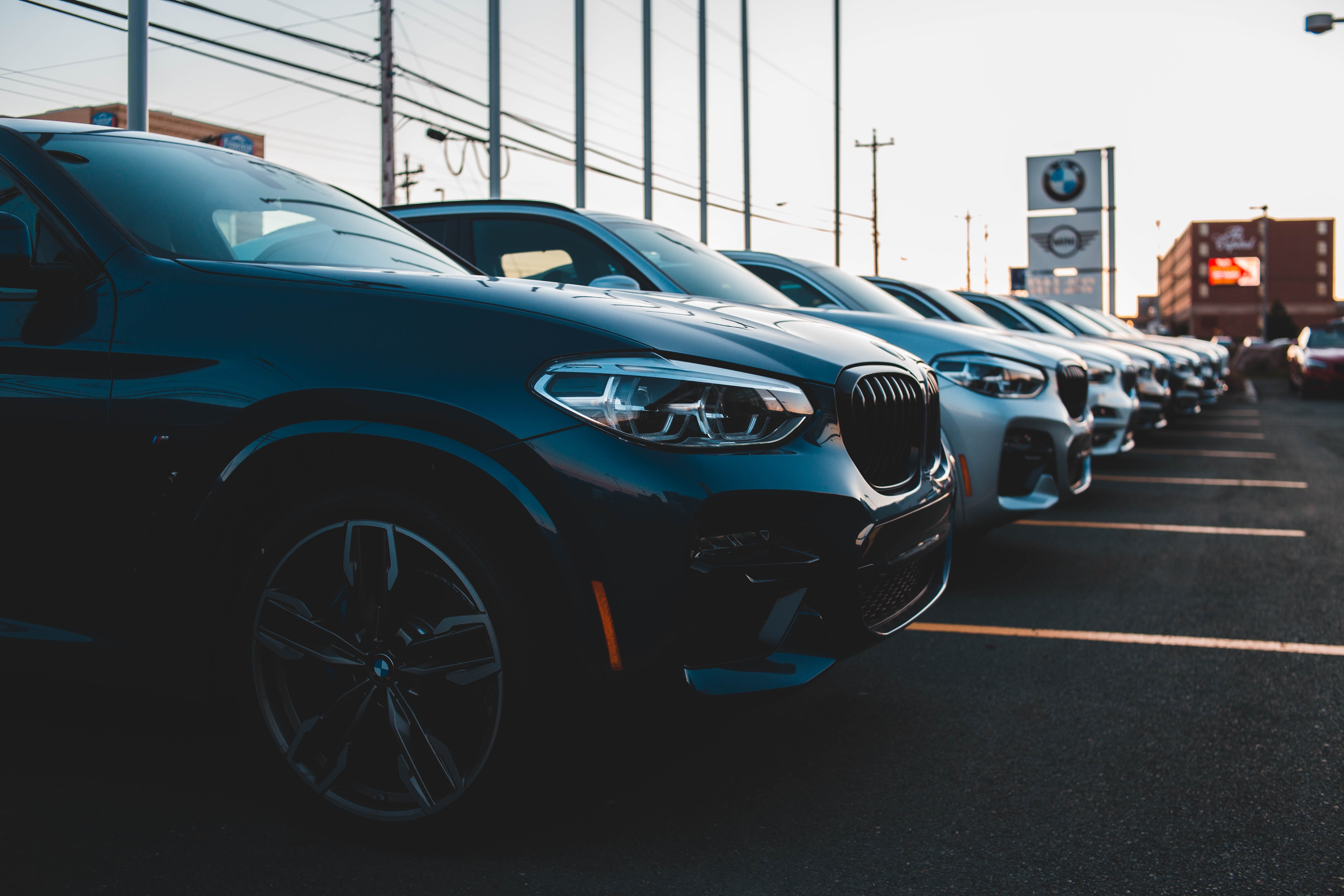 New cars lined up at a car dealership.